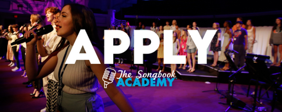 Apply The Songbook Academy. Singers perform on a colorful stage.