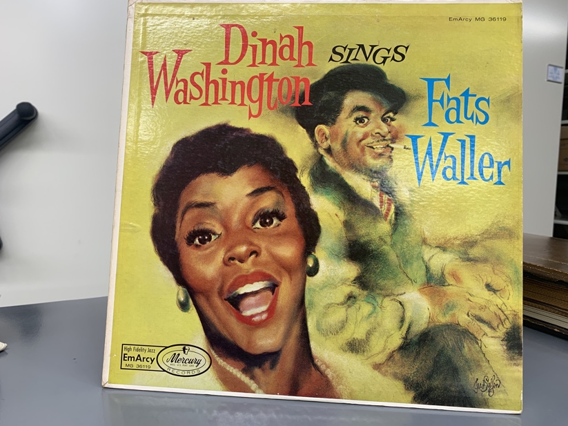 A yellow vinyl cover that reads "Dinah Washington Sings Fats Waller". Artist renditions of Dinah and Fats are shown.