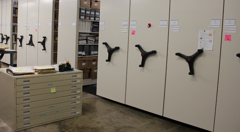 Grey movable shelves are aligned with archival boxes filling them.