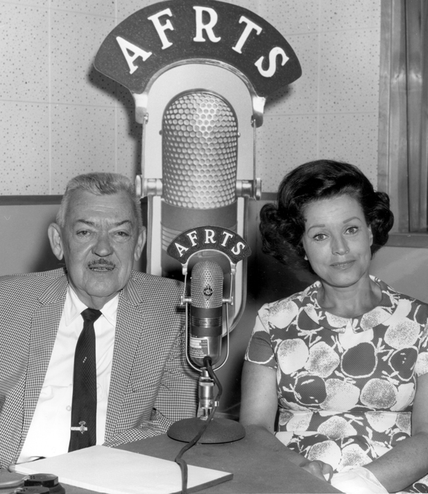 Kay Starr and Andy Mansfield sit between a larger and smaller microphone with the acronymn A.F.R.T.S.