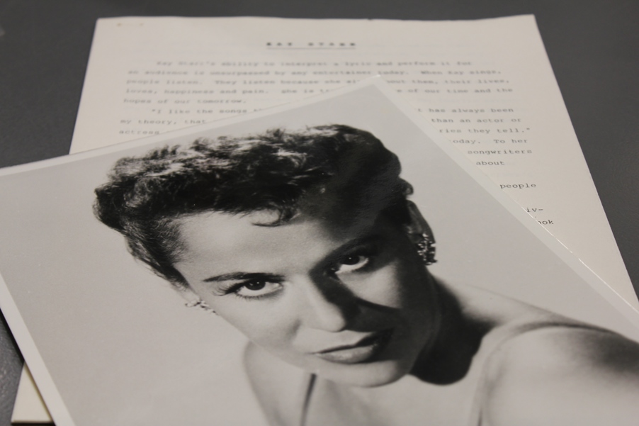 A headshot of singer Kay Starr with blazing eyes and dramatic lighting.