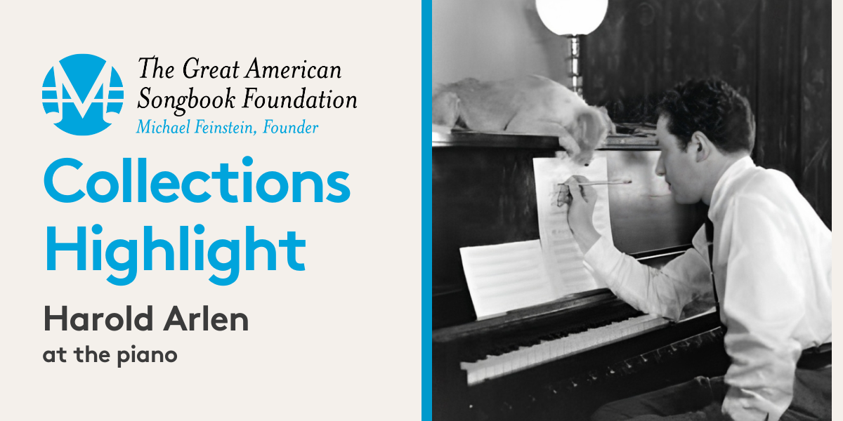 The Great American Songbook Foundation Collection Highlight: Harold Arlen at the piano. An image of composer Harold Arlen sitting at his piano and writing on sheet music. His dog is drapped over the piano.