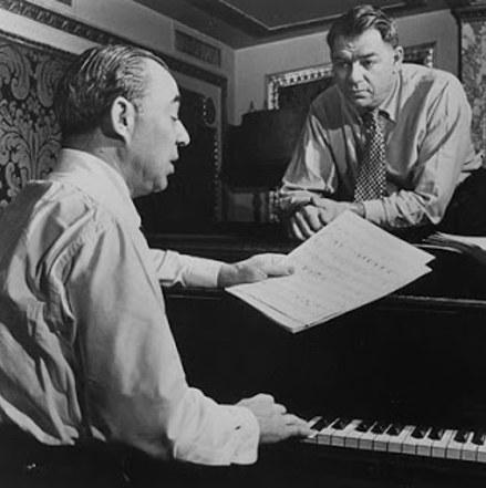 Richard Rodgers and Oscar Hammerstein composing at the piano.