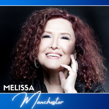 Melissa Manchester with wild curly red hair and a huge smile.