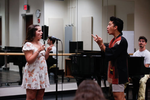 Vocal coach Devin Ilaw leads a Songbook Academy student and Music Director Caelan Cordello accompanies on the piano in rehearsal.