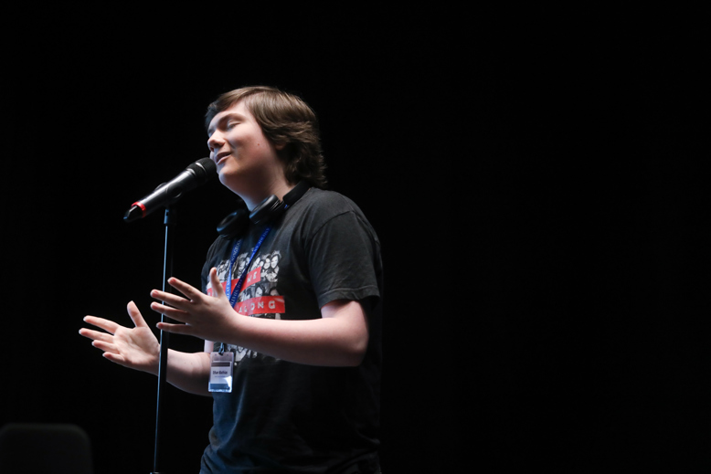 One singer peforms in front of a microphone.