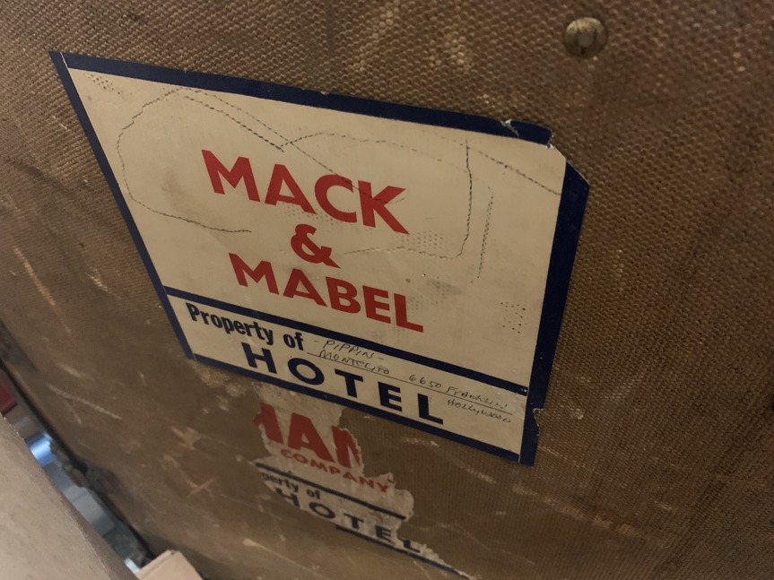 Mack and Mabel is stamped in red on the inside of a traveling trunk.