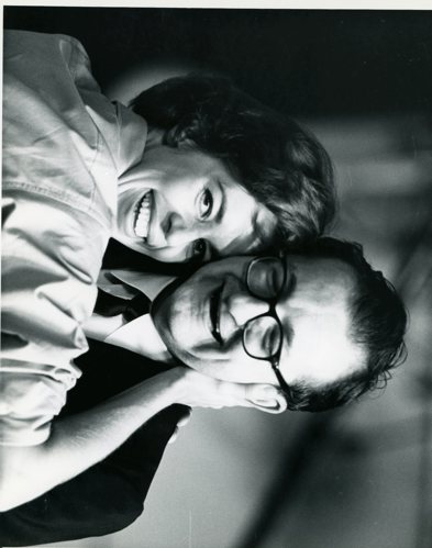 Black & white image of Carol Burnett and Irwin Kostal embrace and smile