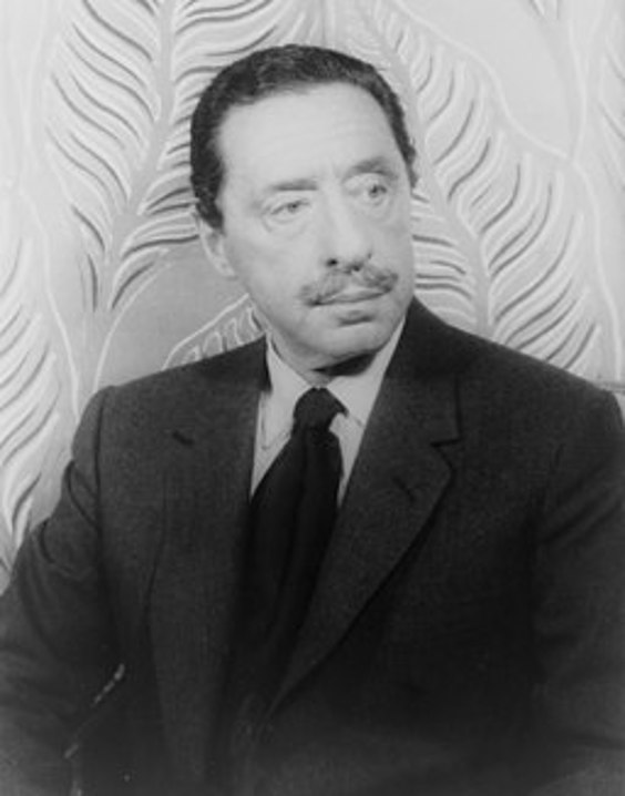 Composer Harold Arlen is in a suit and tie with a wispy mustache and looks to the left. Behind him is an ornate flower background.
