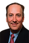 Headshot of a man wearing a suit and red tie