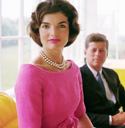 Jackie Kennedy in foreground and John F. Kennedy in background.