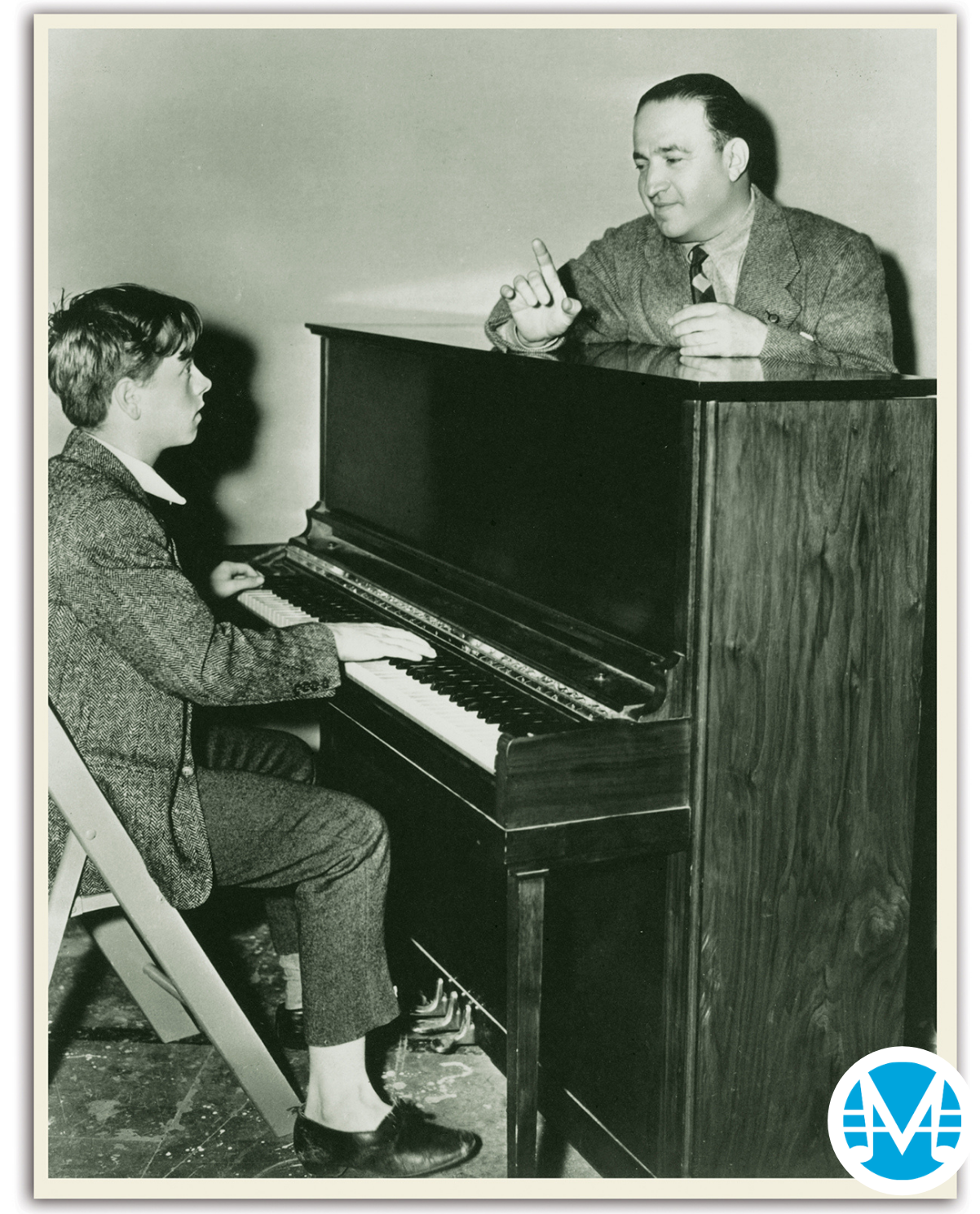 Gus Kahn instructs a young Mickey Rooney to play piano.