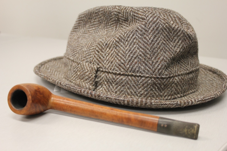 A tweed hat and wooden pipe that belonged to Bing Crosby.
